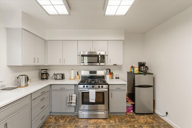 kitchen featuring gray cabinetry and appliances with stainless steel finishes