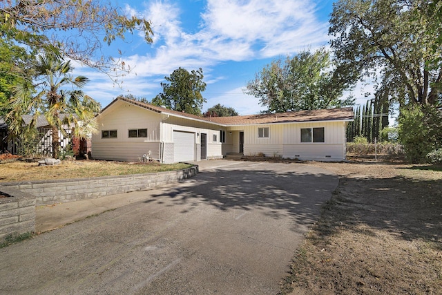 ranch-style home featuring a garage