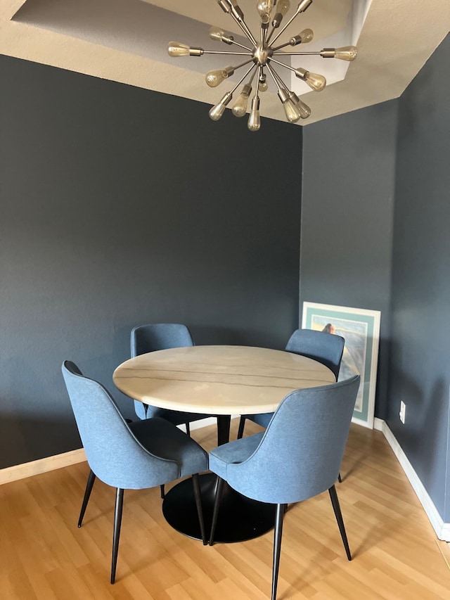 dining room with an inviting chandelier and hardwood / wood-style flooring