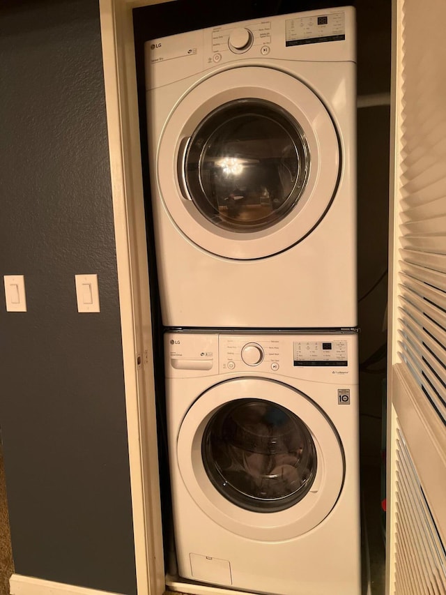 laundry area featuring stacked washing maching and dryer