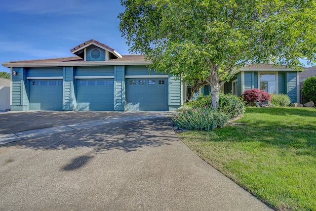 view of front of property with a garage and a front lawn