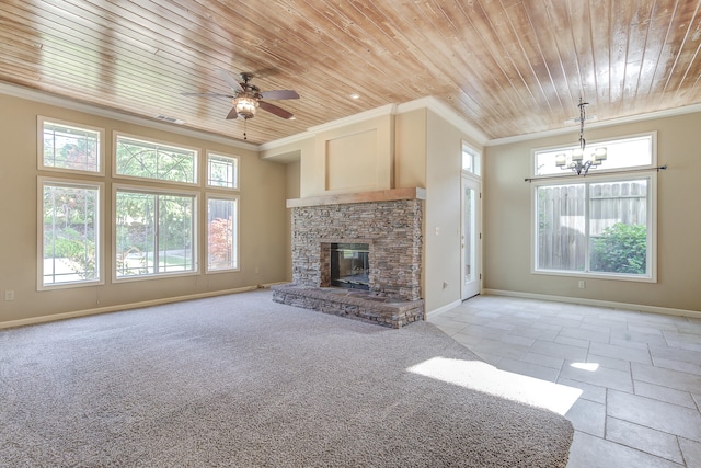 unfurnished living room with wood ceiling, a stone fireplace, and plenty of natural light