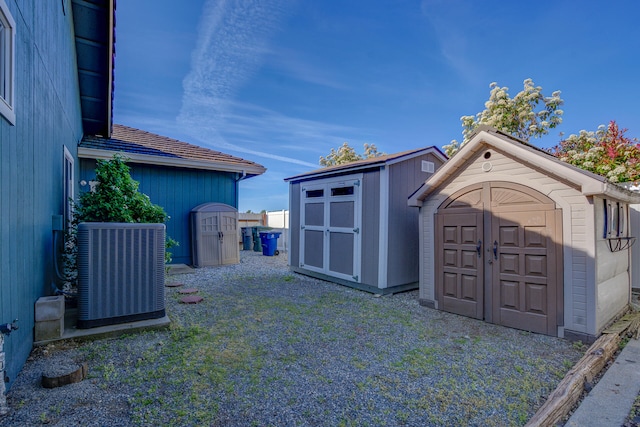 view of yard featuring a shed and central air condition unit