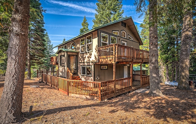 back of house with a wooden deck