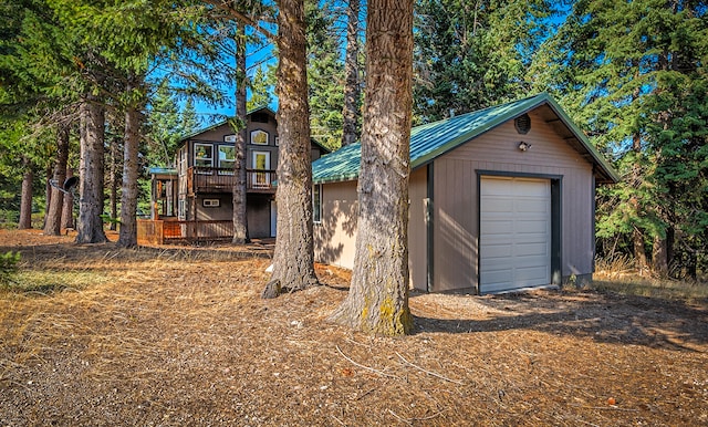 view of front of house featuring an outdoor structure, a wooden deck, and a garage