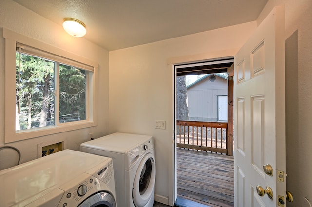 washroom with wood-type flooring and washer and clothes dryer