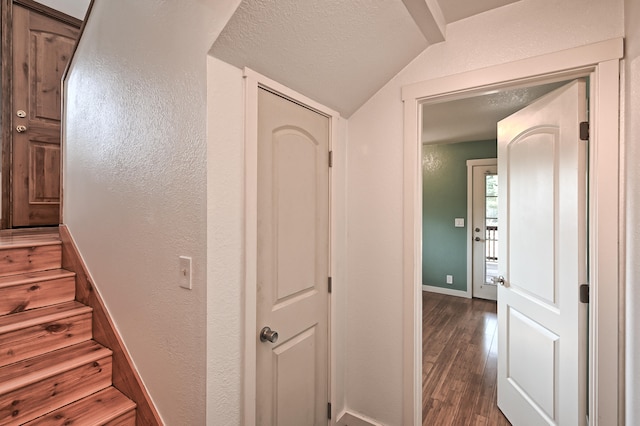 staircase with vaulted ceiling and hardwood / wood-style floors