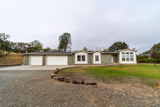 ranch-style house featuring a garage and a front yard