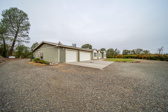 view of side of home featuring a garage