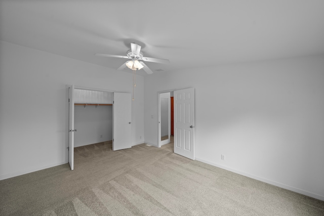 unfurnished bedroom with ceiling fan, a closet, and light colored carpet