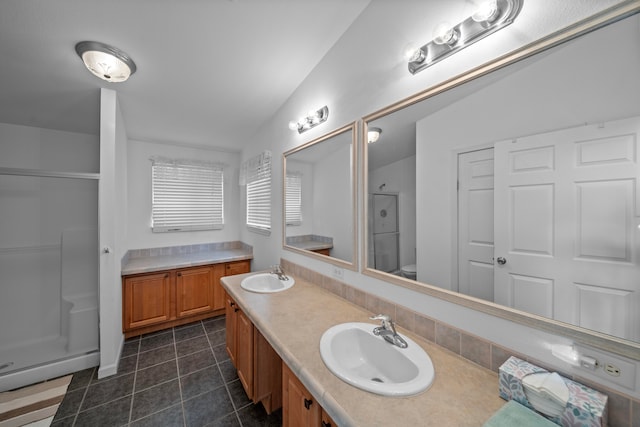 bathroom with lofted ceiling, toilet, vanity, and a shower with shower door