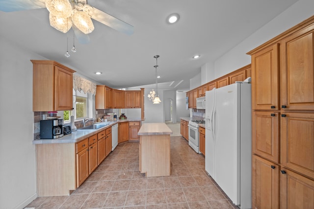 kitchen featuring ceiling fan with notable chandelier, a center island, sink, backsplash, and white appliances