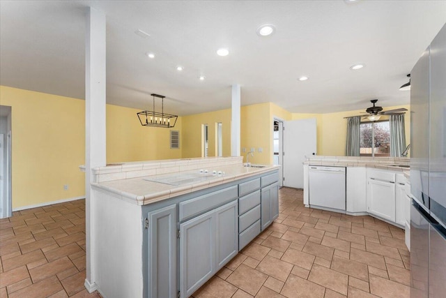 15540 China Rapids Dr, Red Bluff, CA 96080 - kitchen with white appliances, a sink, a peninsula, tile countertops, and recessed lighting
