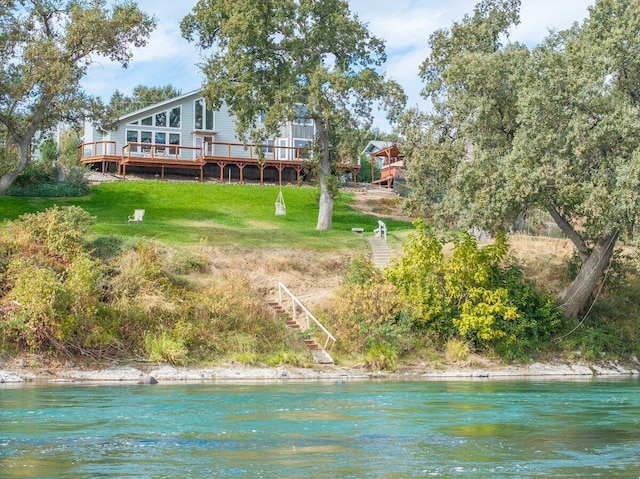 back of property featuring a deck with water view