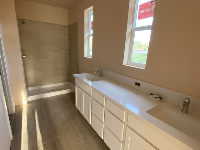 bathroom featuring vanity and a tile shower