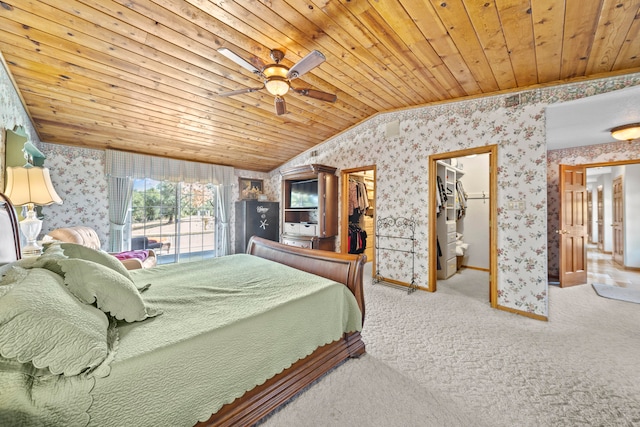 bedroom featuring a walk in closet, ceiling fan, wood ceiling, and vaulted ceiling