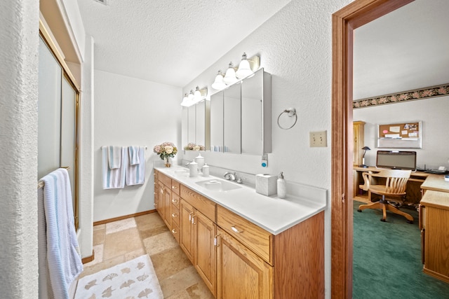 bathroom featuring vanity and a textured ceiling