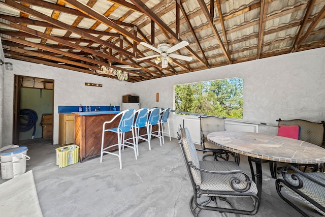 view of patio with an outdoor bar and ceiling fan