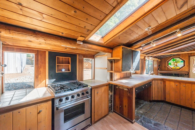 kitchen featuring tile countertops, high end stainless steel range, and wood ceiling