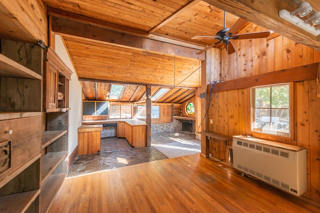 bonus room featuring wood ceiling, dark hardwood / wood-style flooring, radiator, vaulted ceiling with beams, and wood walls