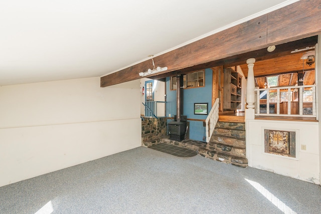 interior space with carpet and a wood stove