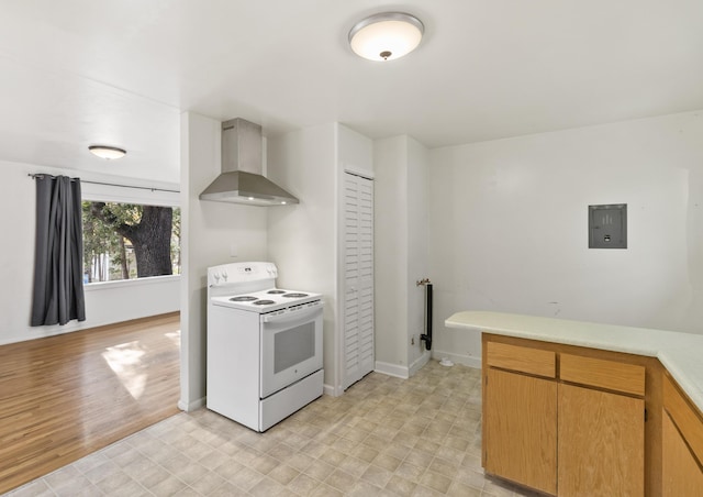 970 Branstetter Ln, Redding, CA 96001 - kitchen featuring electric range, wall chimney range hood, light countertops, electric panel, and baseboards