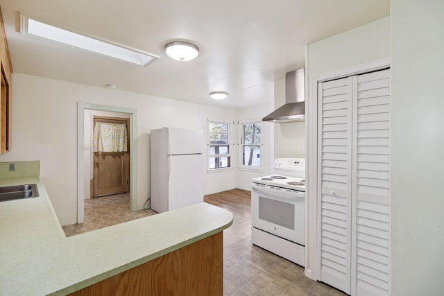 970 Branstetter Ln, Redding, CA 96001 - kitchen featuring white appliances, wall chimney range hood, light flooring, light countertops, and a peninsula