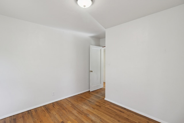 spare room with hardwood / wood-style floors