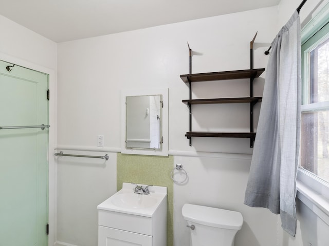 bathroom featuring vanity and toilet