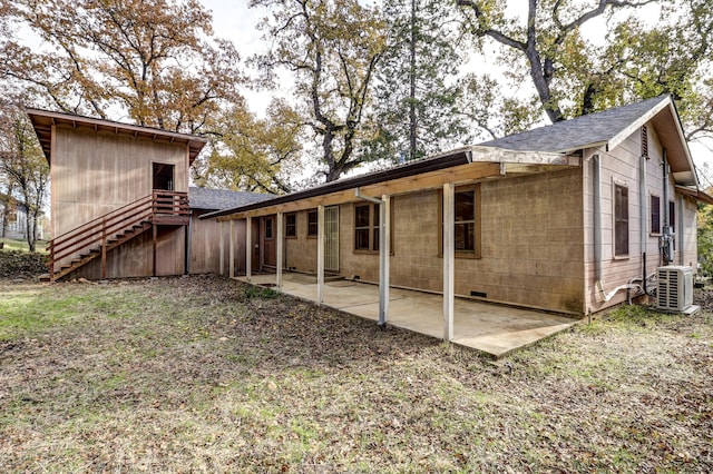 rear view of property featuring central AC and a patio area