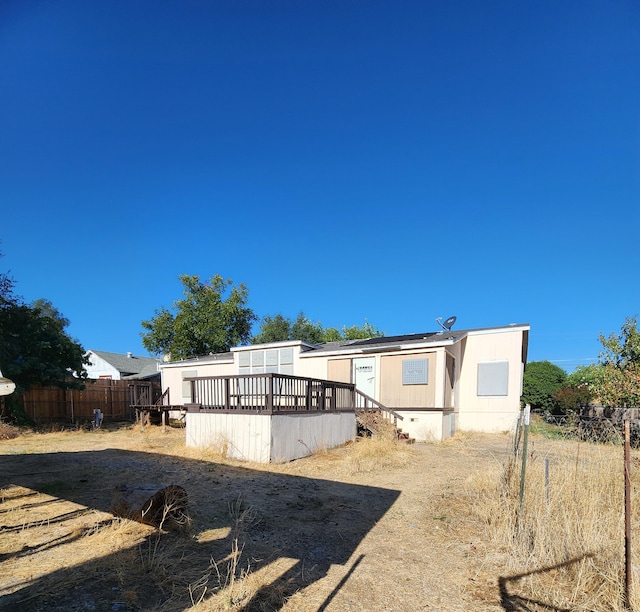 back of house featuring a deck