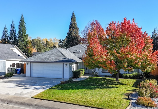 view of front of house with a front yard and a garage