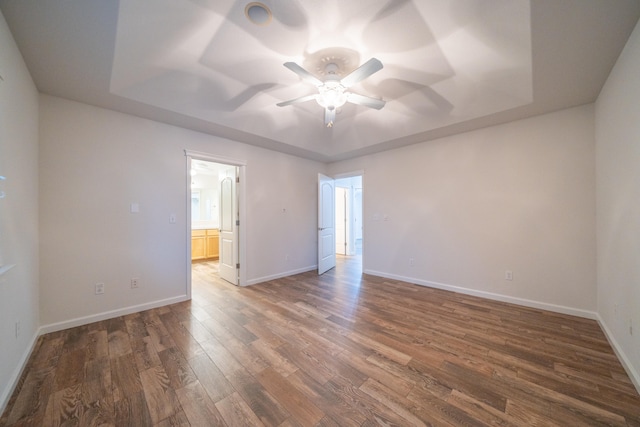 unfurnished room featuring ceiling fan and dark hardwood / wood-style flooring