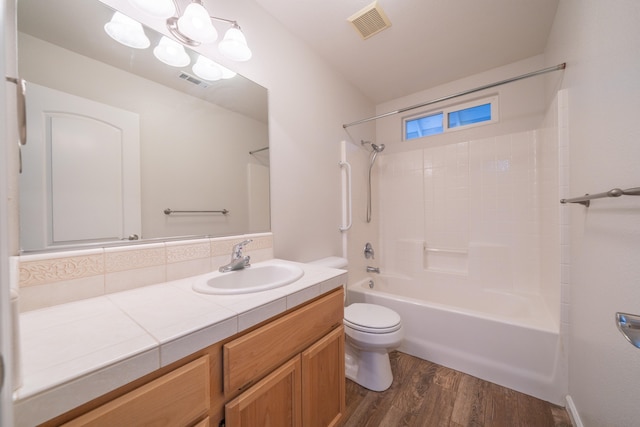 full bathroom with vanity, toilet, shower / bathing tub combination, and hardwood / wood-style flooring