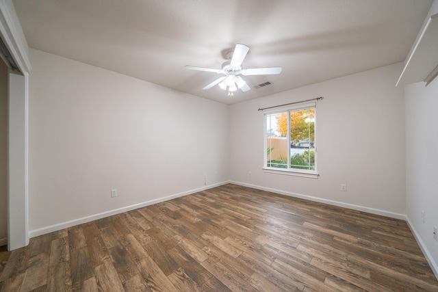 unfurnished room with ceiling fan and dark hardwood / wood-style flooring