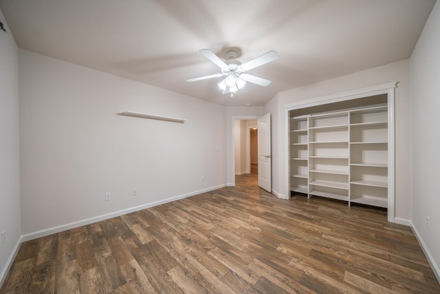 unfurnished bedroom featuring a closet, dark hardwood / wood-style floors, and ceiling fan