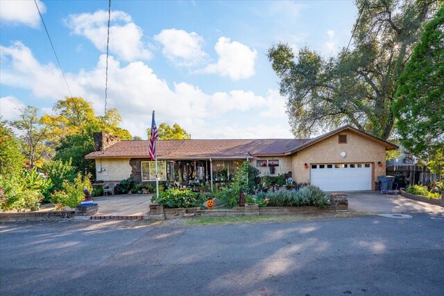 385 Manzanita Ln, Redding, CA 96002 - ranch-style home with a garage, driveway, a chimney, and stucco siding
