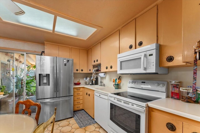 kitchen featuring white appliances and sink