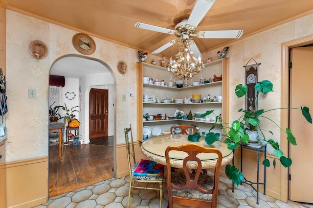 dining space with crown molding, light hardwood / wood-style floors, and ceiling fan with notable chandelier