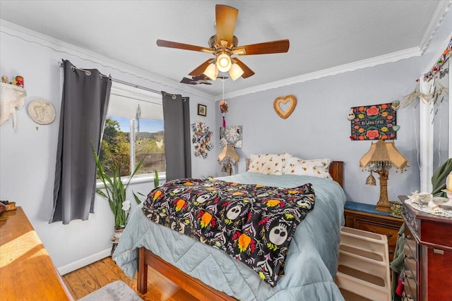 bedroom with ceiling fan, hardwood / wood-style floors, and crown molding