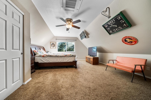 carpeted bedroom featuring ceiling fan, a textured ceiling, and vaulted ceiling