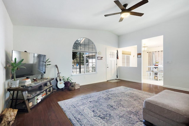 living room with ceiling fan, lofted ceiling, and dark hardwood / wood-style flooring