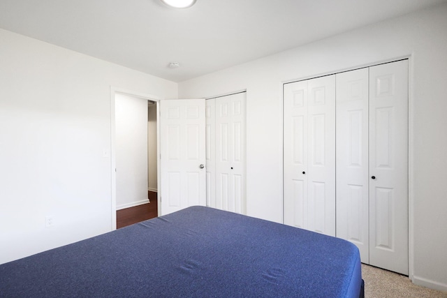 unfurnished bedroom featuring two closets