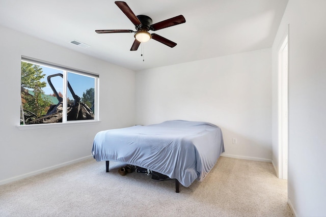 bedroom featuring light colored carpet and ceiling fan