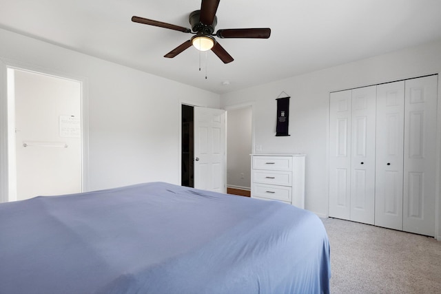 carpeted bedroom featuring ceiling fan and a closet