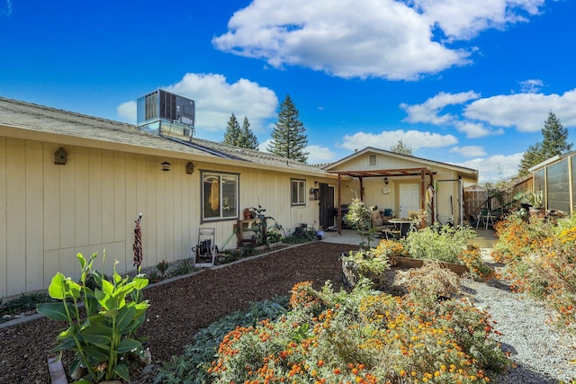 ranch-style house with a patio and central AC unit