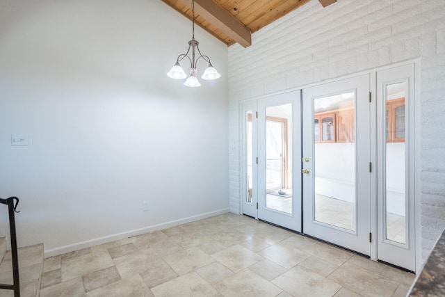 entryway featuring wood ceiling, french doors, lofted ceiling with beams, and a notable chandelier