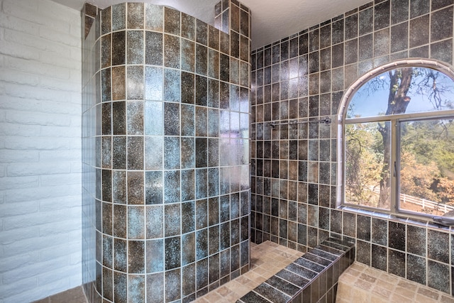 bathroom featuring a healthy amount of sunlight and a tile shower