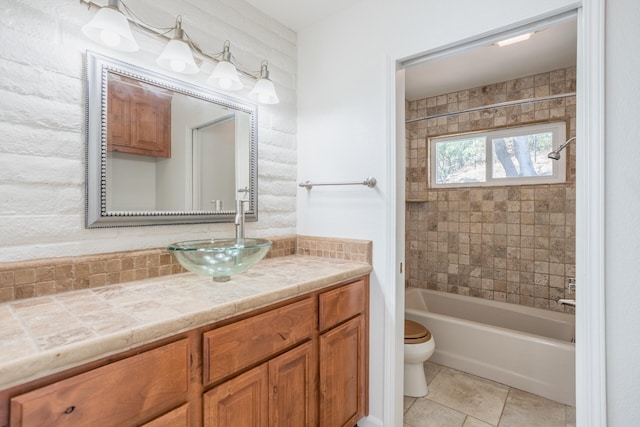 full bathroom with tile patterned flooring, vanity, toilet, and tiled shower / bath