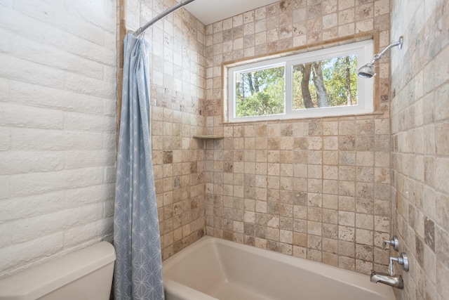 bathroom with shower / tub combo and toilet